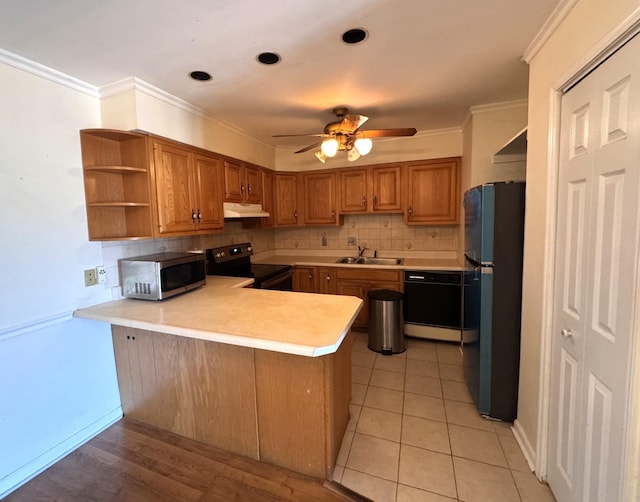 kitchen with ornamental molding, sink, kitchen peninsula, and black appliances