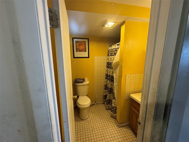 bathroom with tile patterned flooring, vanity, and toilet