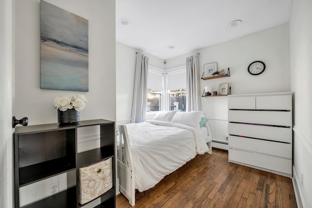 bedroom featuring dark hardwood / wood-style floors and baseboard heating