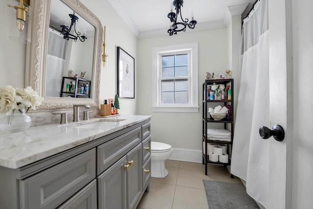 bathroom featuring ornamental molding, vanity, a notable chandelier, toilet, and tile patterned floors