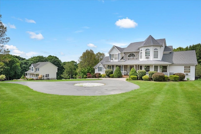 view of front facade with a front yard and covered porch