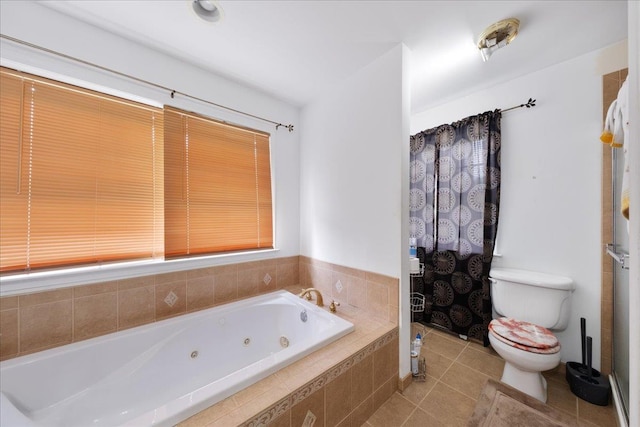 bathroom featuring toilet, tile patterned flooring, and tiled tub