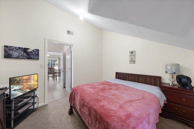 bedroom with vaulted ceiling and carpet flooring