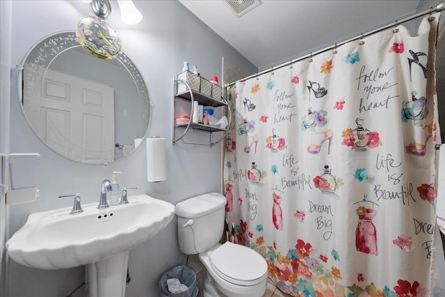 bathroom with sink, toilet, and a shower with shower curtain