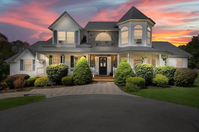 victorian home featuring cooling unit and covered porch