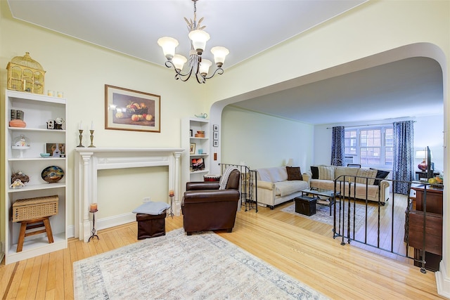 living room with hardwood / wood-style flooring and a notable chandelier