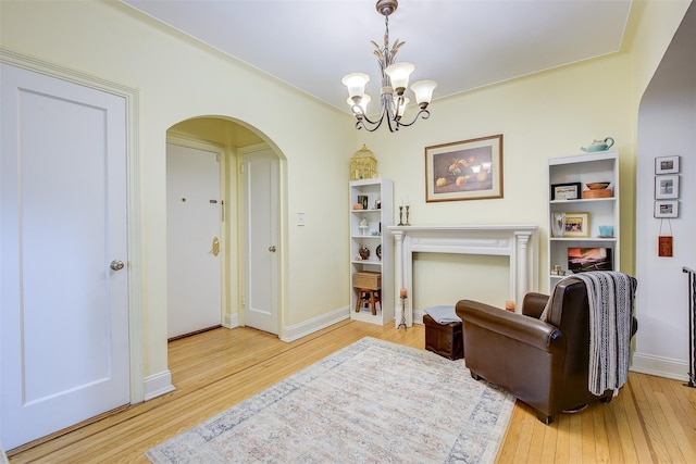 living area with hardwood / wood-style flooring and a chandelier