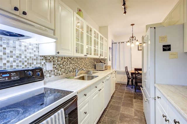 kitchen featuring sink, pendant lighting, white appliances, decorative backsplash, and white cabinets