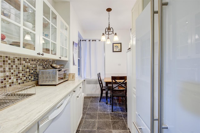 kitchen featuring white cabinetry, tasteful backsplash, light stone counters, white dishwasher, and pendant lighting