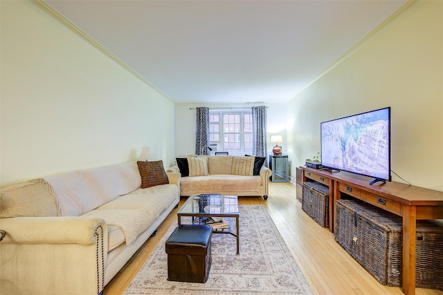 living room with light hardwood / wood-style flooring and ornamental molding