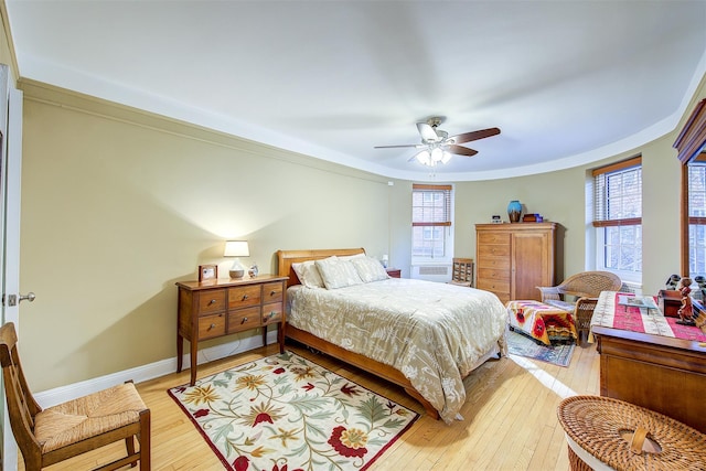 bedroom with multiple windows, light hardwood / wood-style flooring, ornamental molding, and ceiling fan