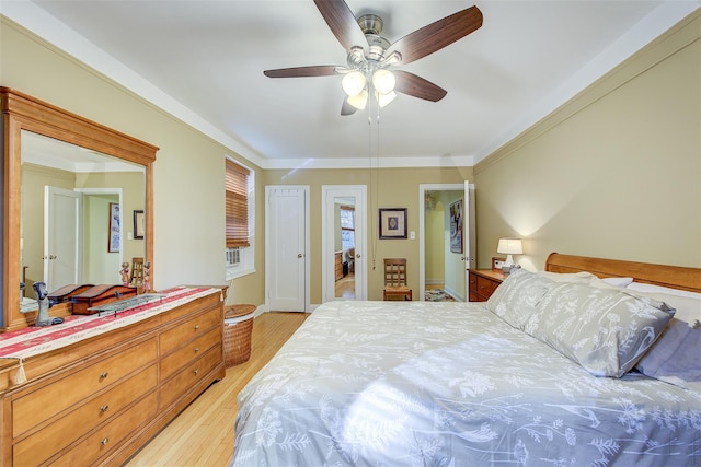 bedroom with crown molding, ceiling fan, and light hardwood / wood-style floors