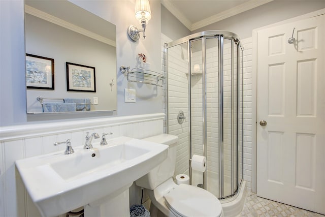 bathroom with ornamental molding, toilet, an enclosed shower, and sink