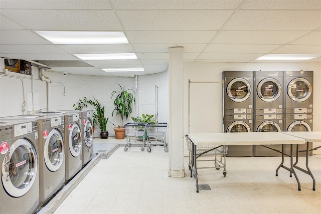 washroom with stacked washer and clothes dryer and washing machine and clothes dryer