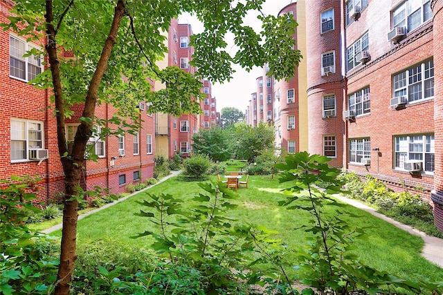 view of property's community with a lawn