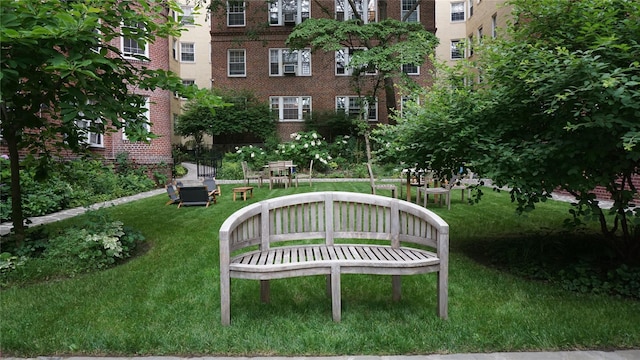 view of home's community with a yard