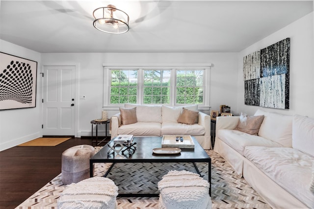 living room with wood-type flooring, a chandelier, and a baseboard heating unit