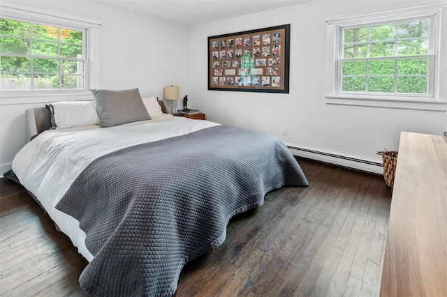 bedroom with dark wood-type flooring and a baseboard radiator