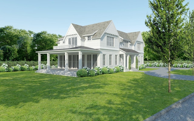 view of front of property with a balcony and a front lawn