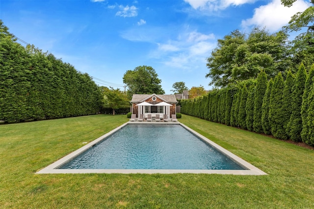 view of swimming pool with an outdoor structure and a lawn