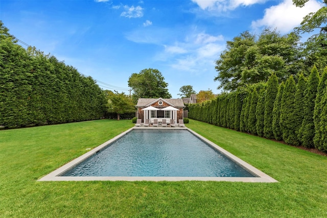 view of pool with a yard and an outdoor structure