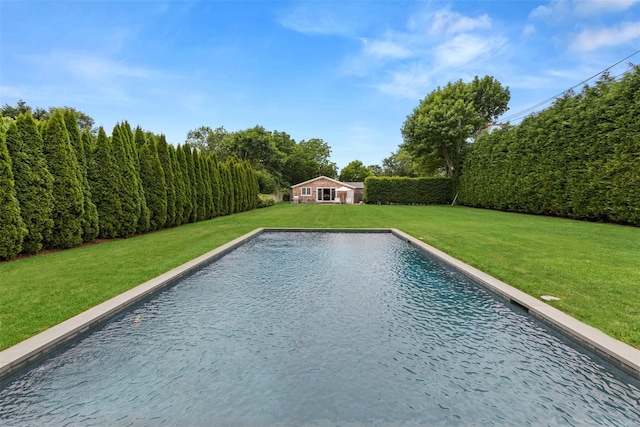 view of swimming pool featuring an outbuilding and a yard