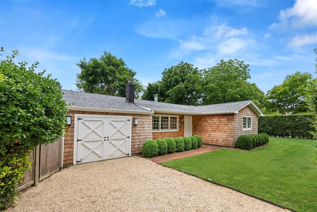 view of front of property featuring a garage and a front yard