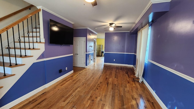 unfurnished living room featuring crown molding, ceiling fan, and hardwood / wood-style flooring