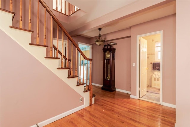 interior space with beamed ceiling and wood-type flooring