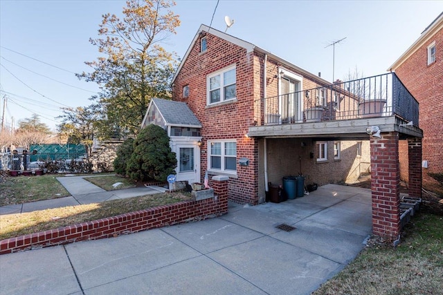 view of side of home featuring a balcony