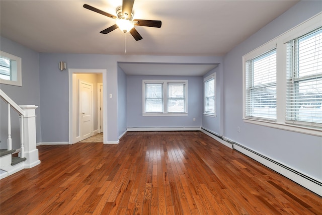 interior space featuring hardwood / wood-style flooring, ceiling fan, and baseboard heating