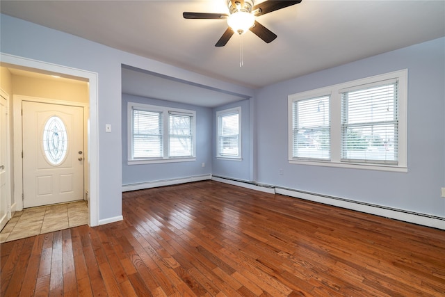 entryway with hardwood / wood-style flooring, ceiling fan, and a baseboard radiator