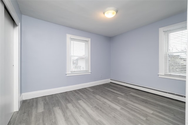 interior space with baseboard heating and light hardwood / wood-style flooring