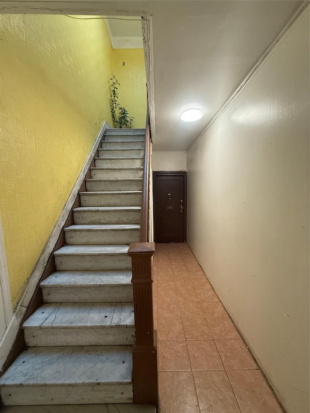 stairway featuring tile patterned floors