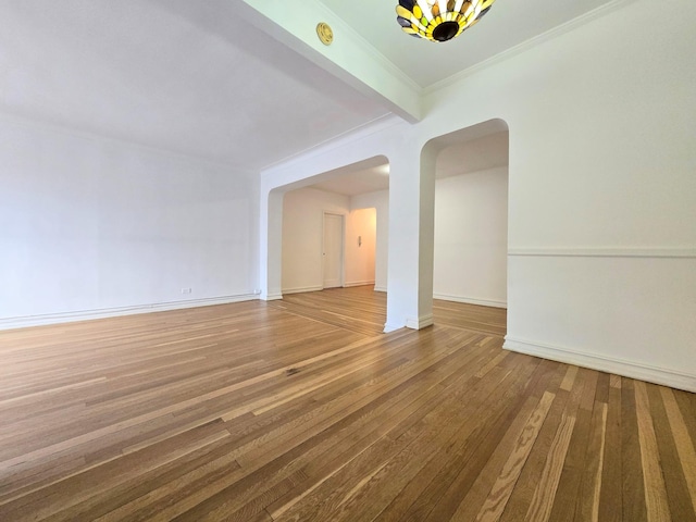 unfurnished living room with beamed ceiling, crown molding, and hardwood / wood-style floors