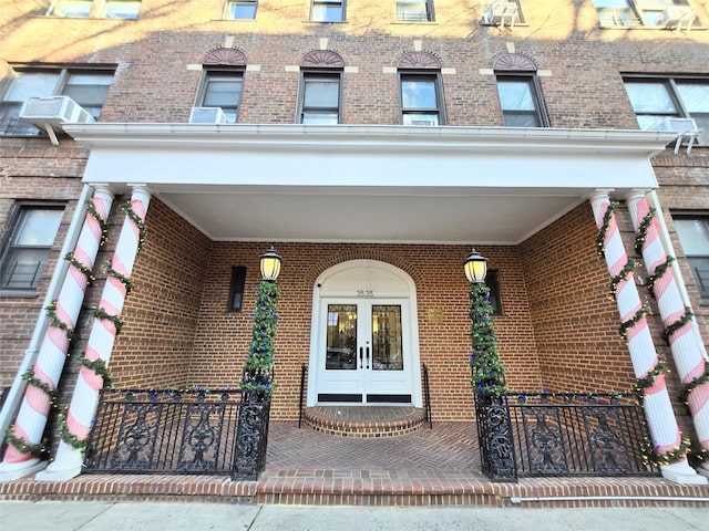 entrance to property featuring french doors and covered porch