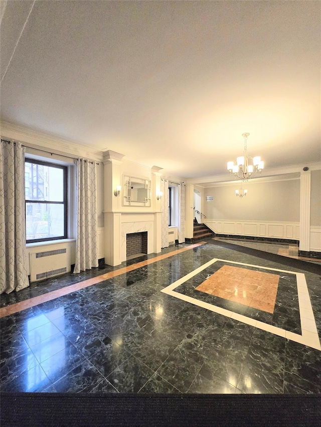 interior space featuring ornamental molding, radiator, and a notable chandelier