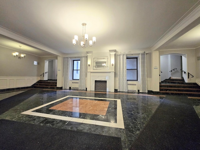 interior space with a premium fireplace, crown molding, and a chandelier