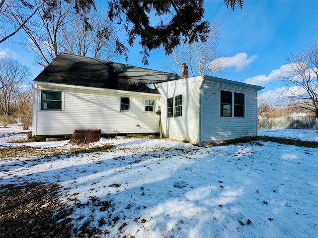 view of snow covered rear of property