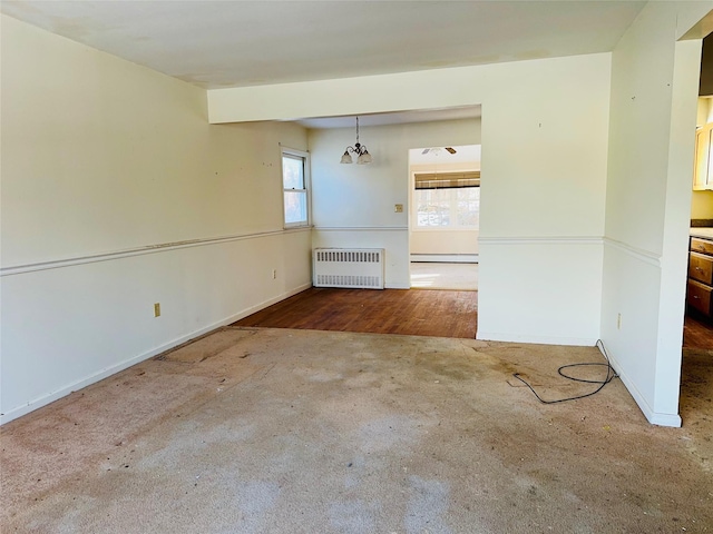 spare room with baseboard heating and radiator