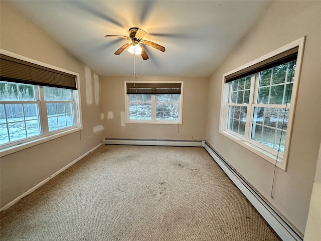 empty room featuring a baseboard radiator, vaulted ceiling, carpet floors, and ceiling fan