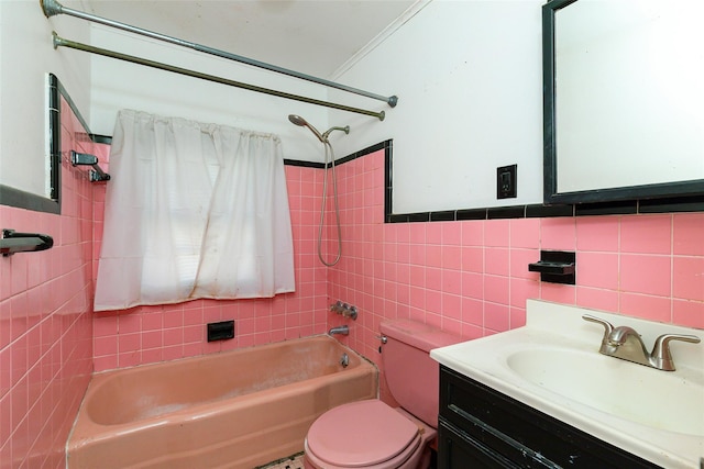 full bathroom with vanity, tiled shower / bath combo, tile walls, and toilet