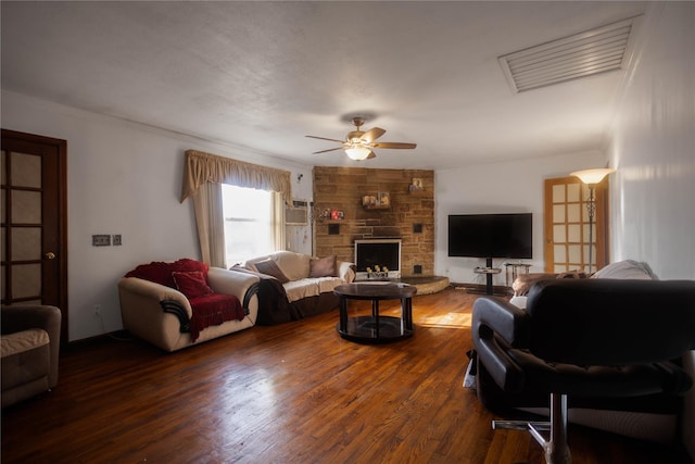 living room with ceiling fan, crown molding, a fireplace, and dark hardwood / wood-style flooring