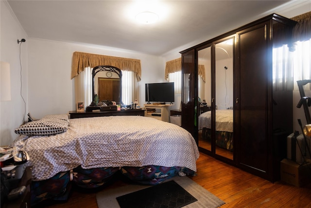 bedroom with dark wood-type flooring