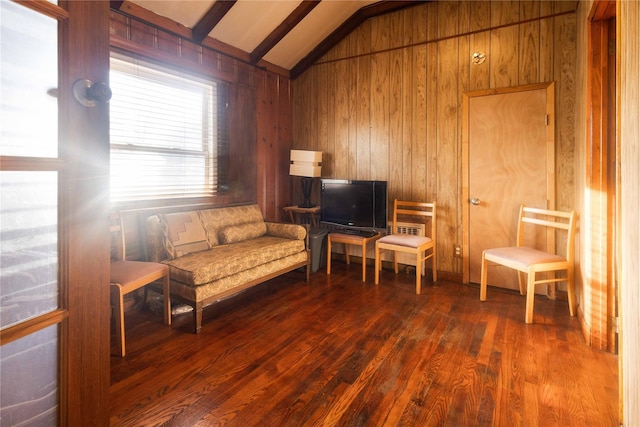 sitting room with vaulted ceiling, wooden walls, and hardwood / wood-style floors