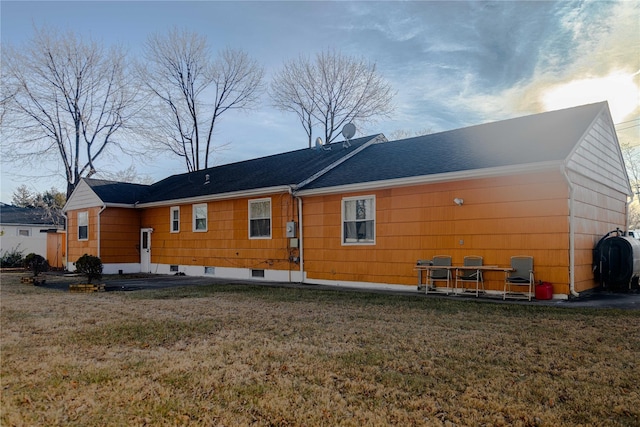 back of property featuring a lawn