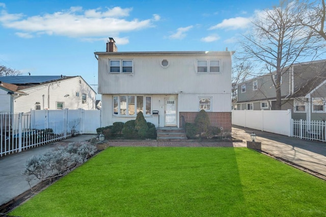 rear view of house featuring a yard