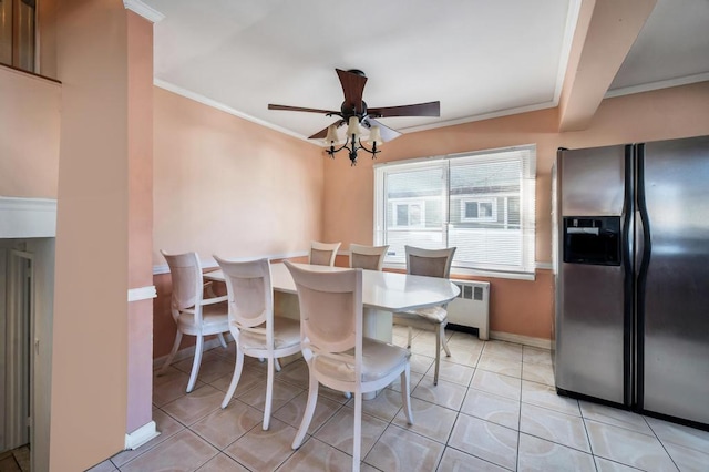 tiled dining area with crown molding, radiator heating unit, and ceiling fan