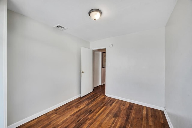 empty room with dark hardwood / wood-style floors