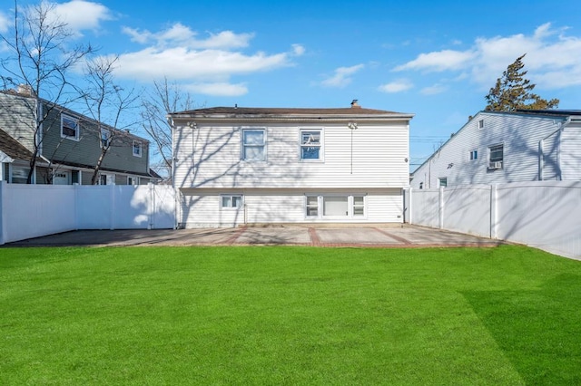 rear view of house featuring a yard and a patio area